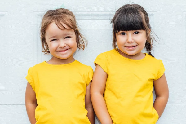 Adorable Twin Girls Wearing Yellow Shirt Leaning White Background — Stock Photo, Image