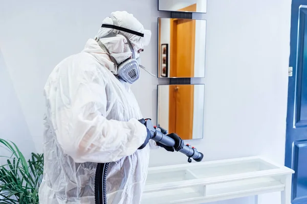 Een Man Met Ppe Een Huis Desinfecteert Een Glazen Tafel — Stockfoto