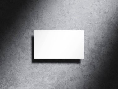 Yumuşak gölgeli çimento arka planda minimal kartvizit.