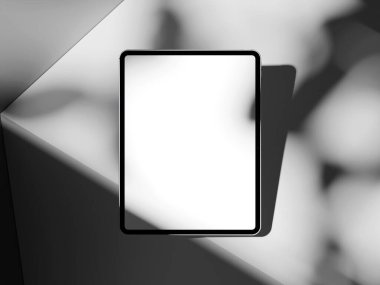 Çimento yüzeyinde çok az gölgesi olan moda tablet modeli, dijital sanat sunumları için mükemmel.