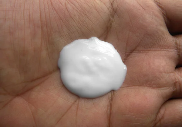 Dollop of white Moisturizing cream on palm of hand