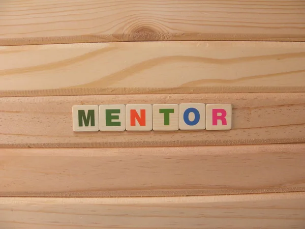 Word Mentor on wood background