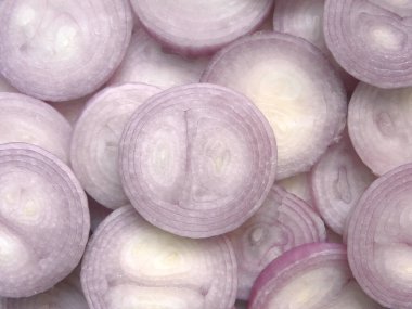 Beyaz ve açık mor renkte dilimlenmiş çiğ soğan.