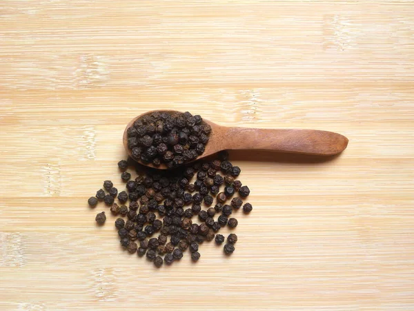 Black Color Raw Whole Dried Pepper Wooden Spoon — Stock Photo, Image