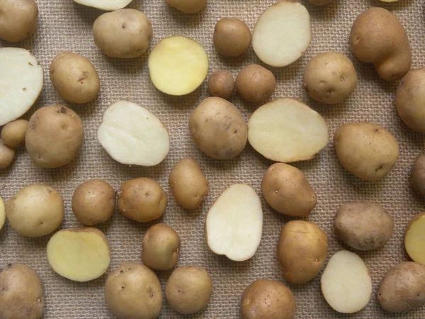 Whole and cut raw fresh baby potatoes