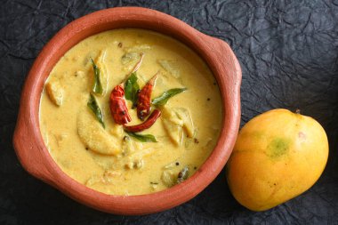 Onam Sadhya ya da Sadya Kerala Hindistan için sarı mango körisi veya Mampazha Pulissery tatlı ve ekşi yemek. organik ham mango, hindistan cevizi sütü, baharatlı köri yaprağı, hardal, Hint kırmızı kaşmir biberi.