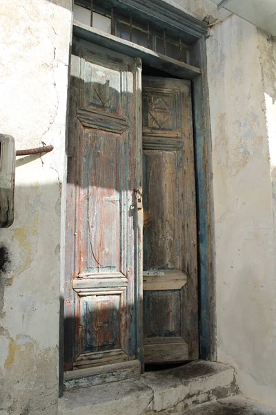 Old wooden open door on the street, lock