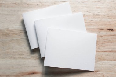 Boş portre mock-up kağıt. Broşür dergi izole kahverengi ahşap masa, değiştirilebilir arka plan / beyaz kağıt ağaç izole