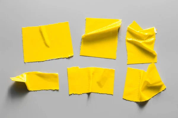 Set of yellow tapes on white background. Torn horizontal and different size yellow sticky tape, adhesive pieces.