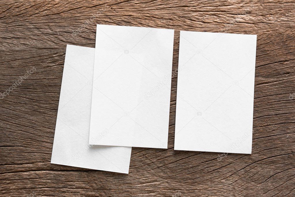 Blank portrait mock-up paper. brochure magazine isolated on brown wooden table, changeable background / white paper isolated on wood