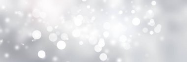 Beyaz ve gri soyut arkaplan. Bokeh Noel 'i güzel, parlak Noel ışıklarını bulanıklaştırdı
