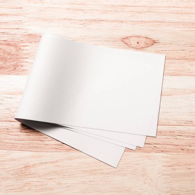 blank white paper sheet on wooden background. mock up, template for design.