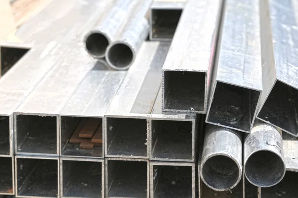 Round and square stainless steel pipes, construction materials, tubes.