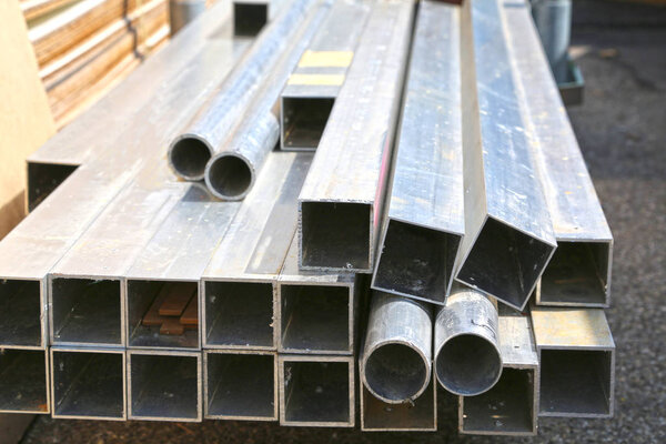 Round and square stainless steel pipes, construction materials, tubes. 