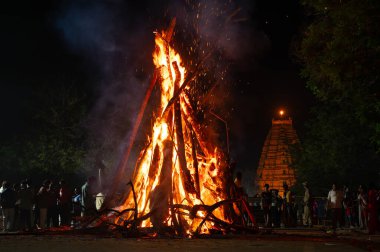 Holika Dahan, ritual bonfire, evening before the holi festival in India, symbol for burning the evil, triumph of good, Hampi, India, march 14th 2025