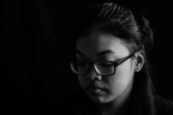 Asian girl with black and white image of background.