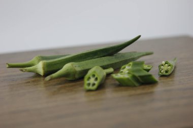 Tahta kiremitlerin üzerinde yatan bamya.