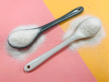 Pembe ve sarı arkaplanda kolajen tozu.