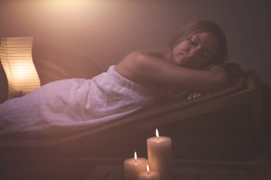 Masaj. Spa salonda mumlar ile güzel kız