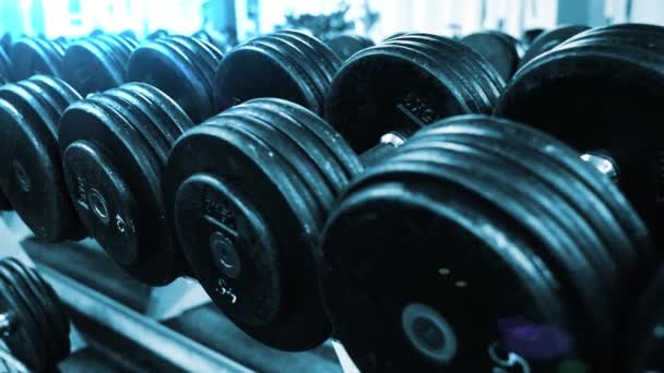 Close up gym dumbbells fitness center sport — Stock Video