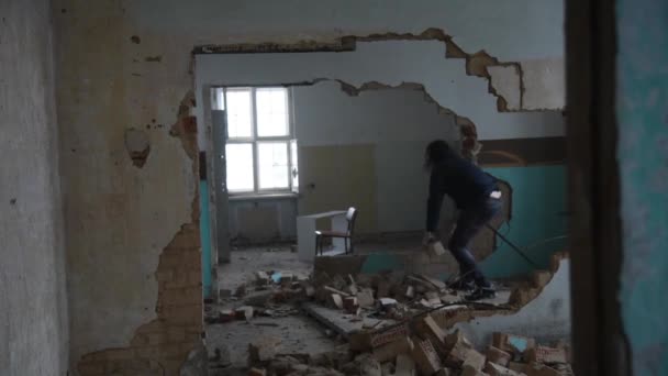 Depressziós és őrült ember dob kövek egy régi, elhagyatott ház — Stock videók