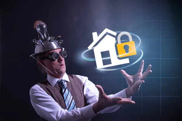 Funny nerd or geek with aluminium hat looking to home insurance icon having an idea