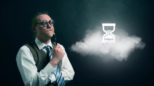 Funny nerd or geek looking to flying cloud with rotating hourglass icon — Stock Video