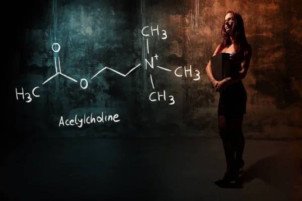 Sexig tjej eller sekreterare eller kvinnlig student presenterar handdrawn kemisk formel av acetylkolin — Stockfoto