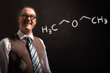 Diethylether'in elle çizilmiş kimyasal formüllerini sunan Profesör