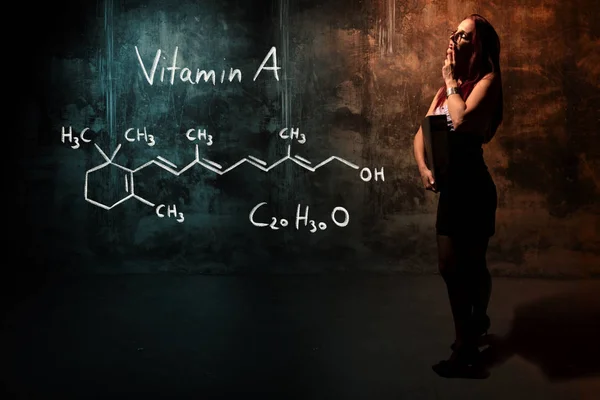 Ragazza sexy o segretaria o studentessa che presenta formula chimica disegnata a mano di vitamina A — Foto Stock