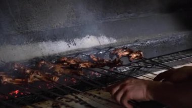 Izgara, kızarmış et, tavuk ızgara, sosis, kebap, hamburger, sebze, barbekü, deniz ürünleri. Izgara biber ve soğan. Yakın çekim güneşli açık hava Şef ızgaradaki eti çeviriyor
