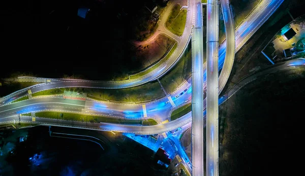 Aerial drone night shot of multilevel illuminated ring highway road junction leading to the sea, Sochi, Russia