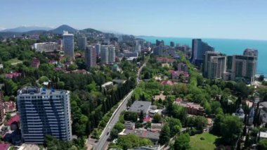 Havadan video çekimi. Karadeniz'de tatil kasabası. Soçi, Rusya. En yüksek bina. Lüks oteller. Şehir merkezi. Mavi gökyüzünü temizle. Yukarıdan panoramik görünüm.