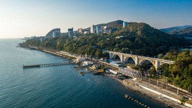 Matsesta rıhtımının insansız hava aracı görüntüsü ve yaz günbatımında viyadük arka planı, Sochi, Rusya. Hava görünümü