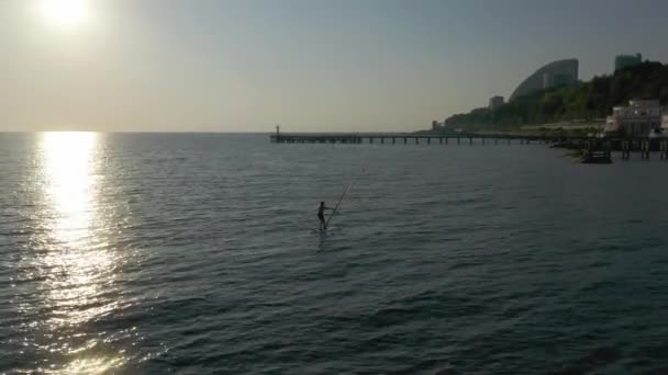 Shot Man Bathing Suit Standing Sup Board Swims Surfing Sea — Stock Video