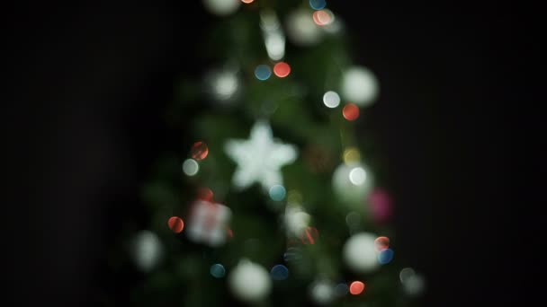Christmas Balls and lights on Christmas Tree. Defocus shot with Colorful bokeh — Stock Footage Christmas Balls and lights on Christmas Tree. Defocus shot with Colorful bokeh Stock Footage