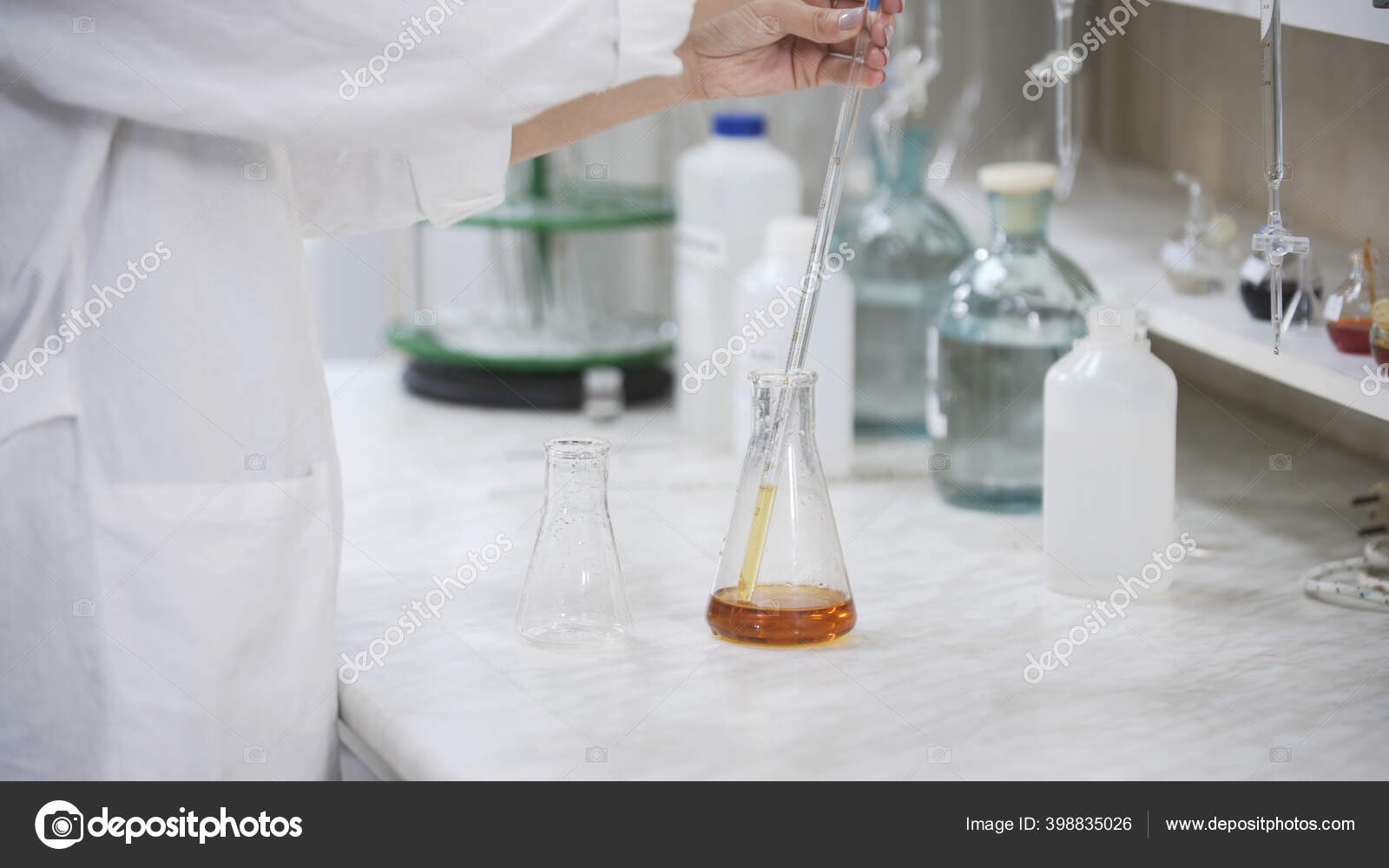Female scientist with pipette analyzes liquid in distillery laboratory