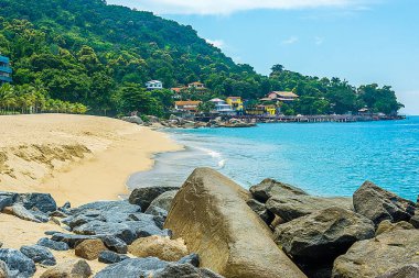 Praia com pedras ve montanhas