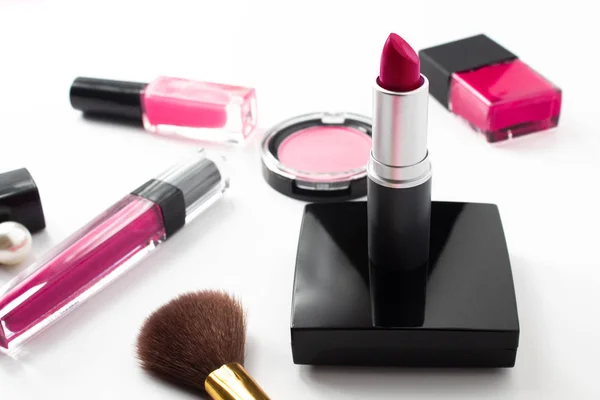 pink gloss lipstick cosmetic with beauty object on white background