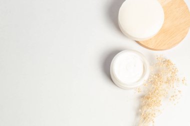 güzellik kozmetik tedavi konseptibeyaz arka plan üzerinde ahşap çanak ile kurutulmuş çiçek ile sabun losyon yüz bitkisel spa kremi 