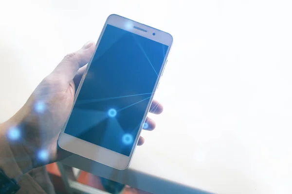 man hand with smartphone on white desk with social network technology