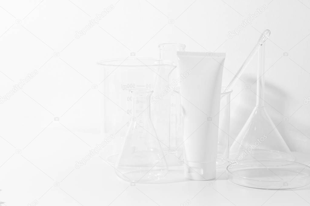 skincare cosmetic mockup lotion bottle pakage on white background, sunscreen protection with laboratory science glass tube