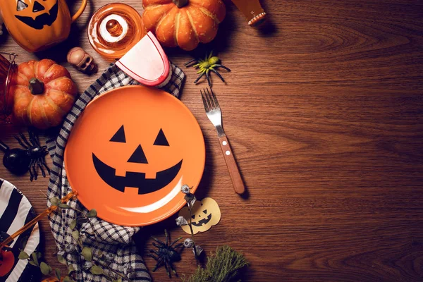 halloween pumpkin with toy decoration prop on wood vintage table top view for dinner on holiday season celebration spooky party concept