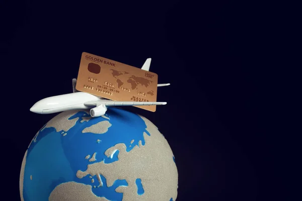 airplane with global world and gold credit card in travel tour and business investment financial network concept, reservation for flight ticket online
