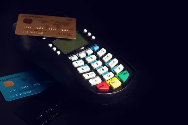 shoping electronic payment device reader machine with gold premium credit card of digital banking investment financial and money concept on black background