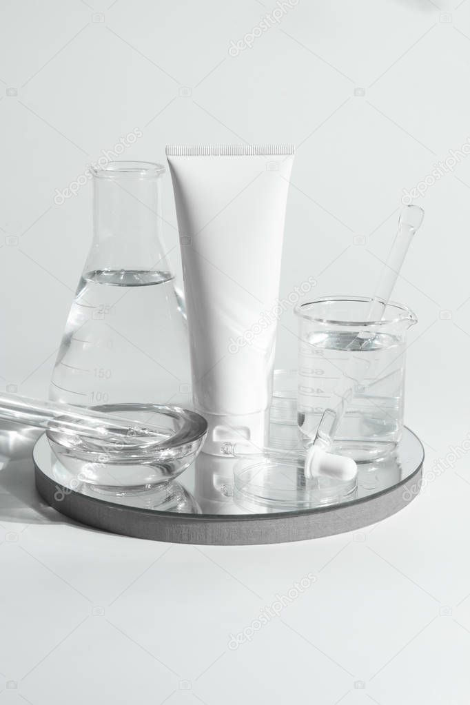 beauty spa medical skincare and cosmetic lotion bottle cream packaging product on white decor background and laboratory test glass tube in doctor healthy science concept