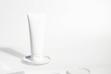 Taze güzellik kaplıcası tıbbi cilt bakımı ve kozmetik krem yüz tüpü beyaz dekor arka planında ambalaj ürünü yaz mevsimi güneşi ışığı
