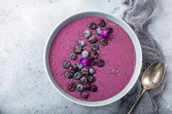 delicious blueberry smoothie bowl with frozen berries. Healthy vegan raw food. top view