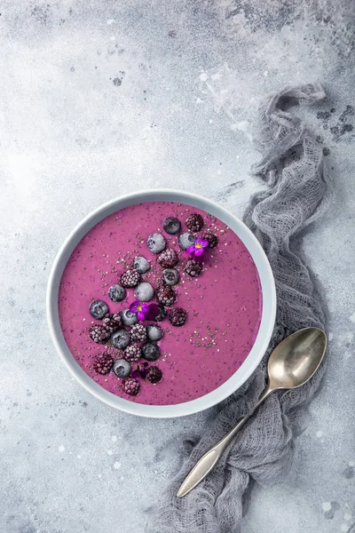 delicious blueberry smoothie bowl with frozen berries. Healthy vegan raw food. top view