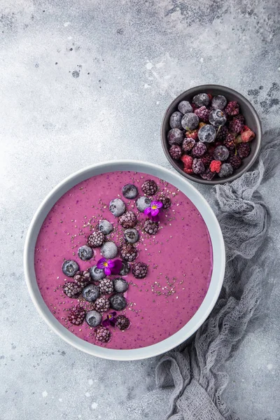 delicious blueberry smoothie bowl with frozen berries. Healthy vegan raw food. top view